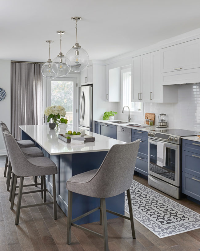 mix of classic with modern of white and blue/grey kitchen cabinetry, white counter-top and modern chairs