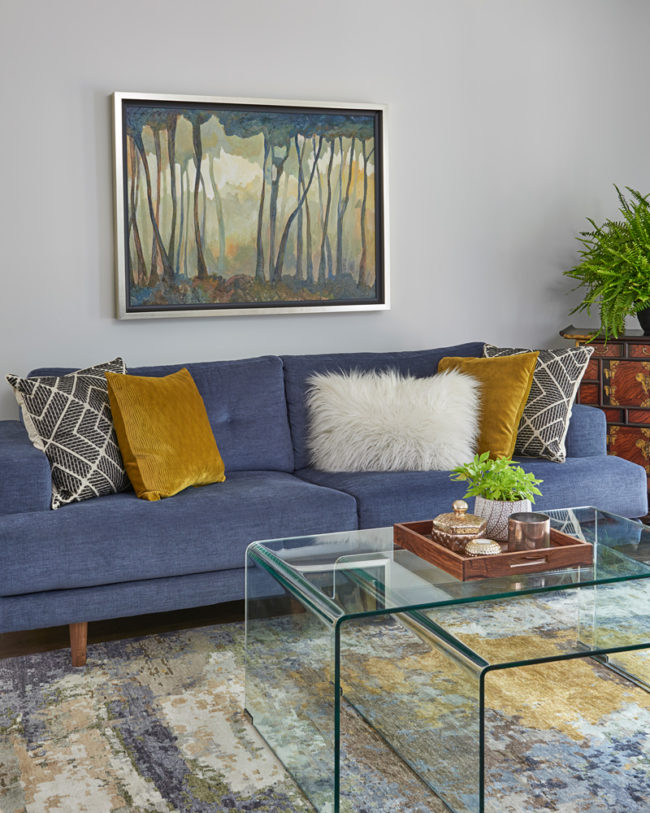 beautiful modern blue sofa and gold fabric pillows - fine finishes design inc