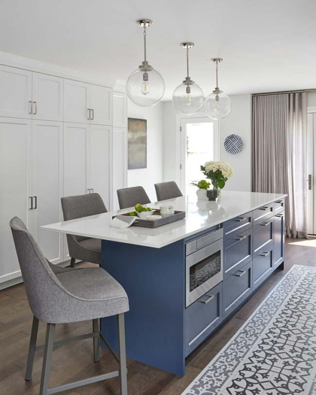 modern blue/grey kitchen island cabinetry with white and grain veins quartz counter-top
