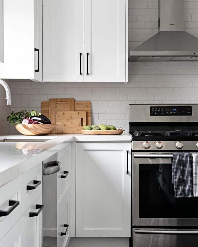 white kitchen cabinetry, stainless steel stove